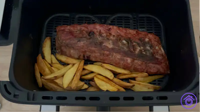 Costillas y patatas cocinadas juntas en la cesta de la Cecofry FoodCourt 18000 4Pizza